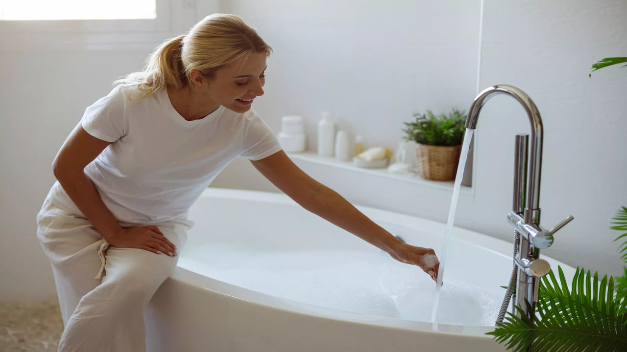 attractive-cheerful-young-woman-pouring-hot-water